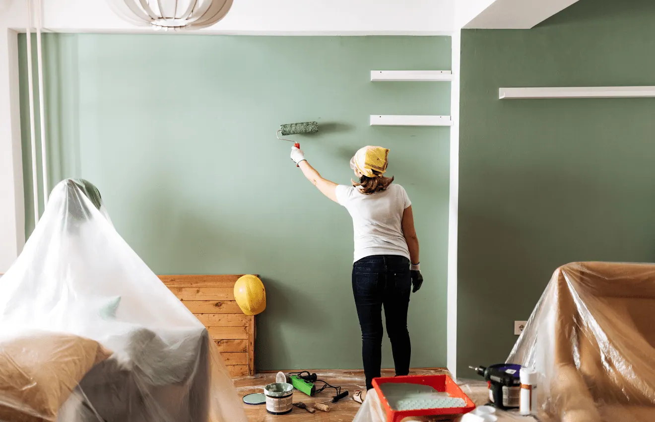 Woman painting on walls: Increasing home value in Virginia Beach
