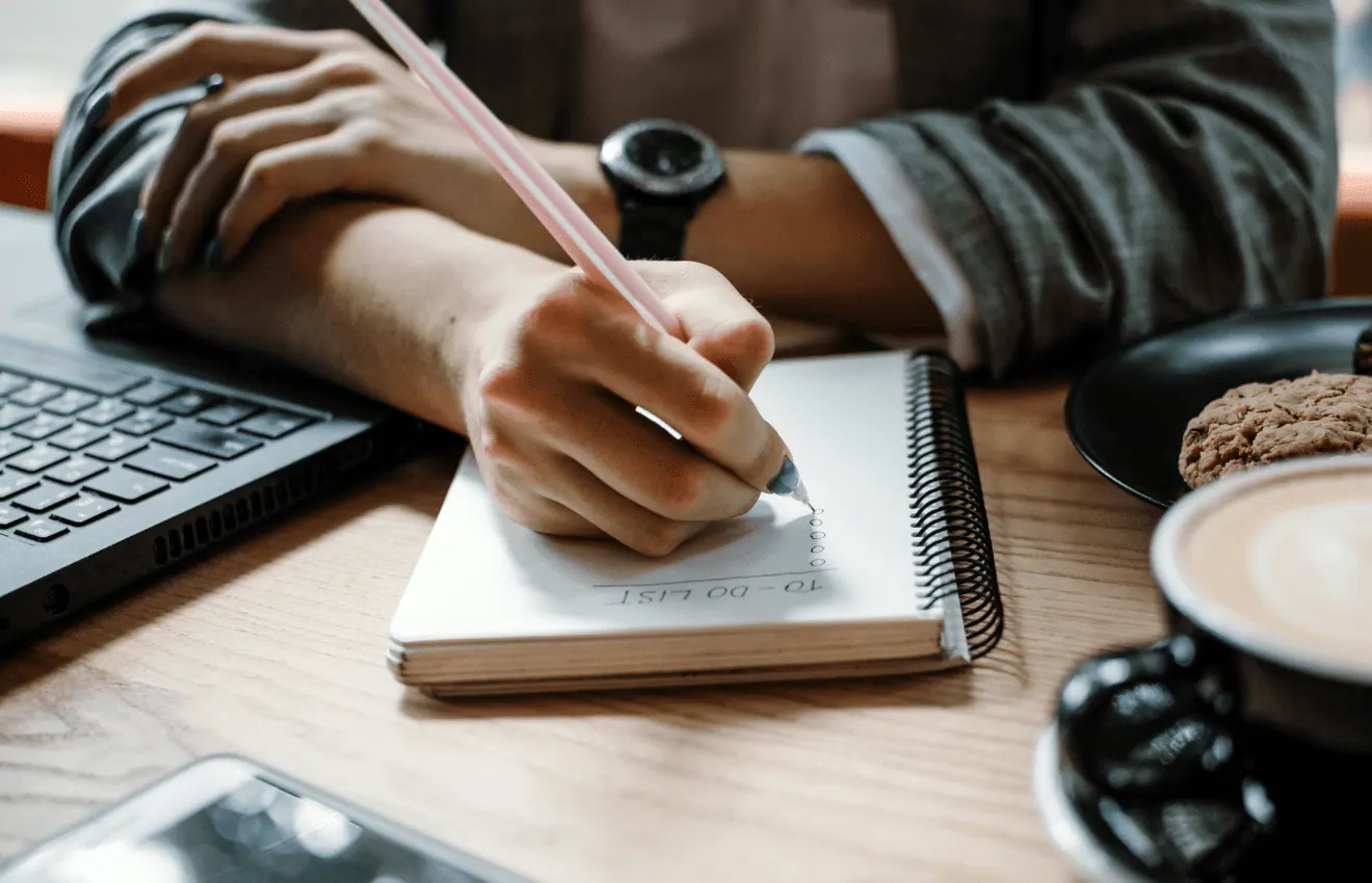 Person Writing To-do List - Must-Do List Before Buying a House