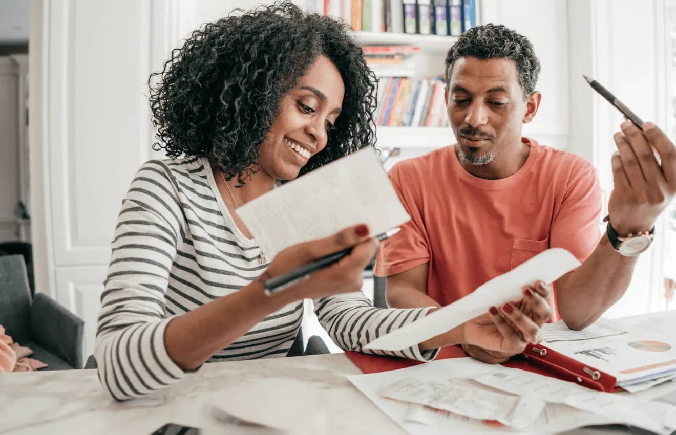 couple with papers and receipts - Cost of Living in Virginia Beach