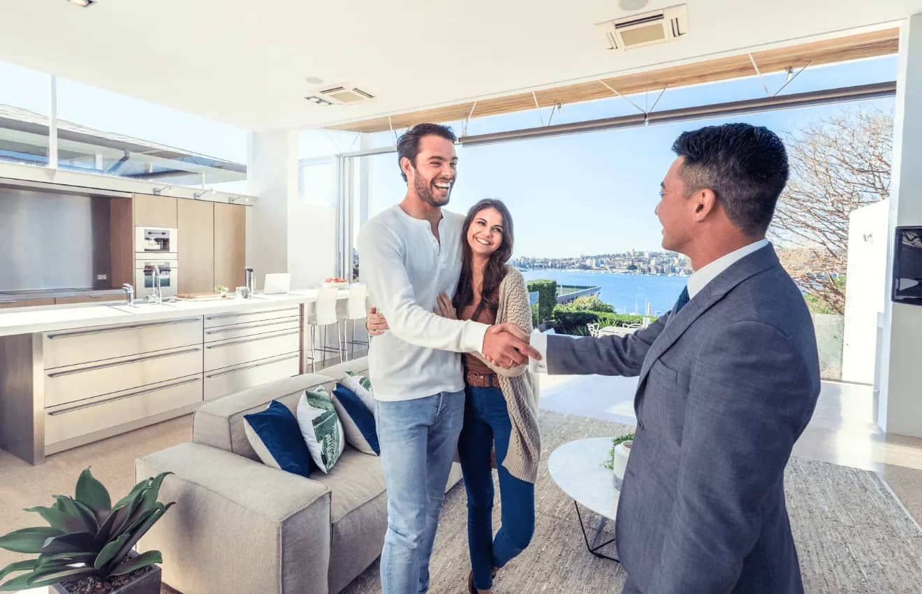 real estate agent with a couple - Role of Real Estate Agents