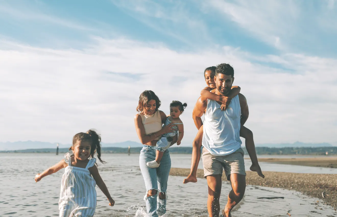 Pros and Cons of Living in Virginia Beach: family on the beach