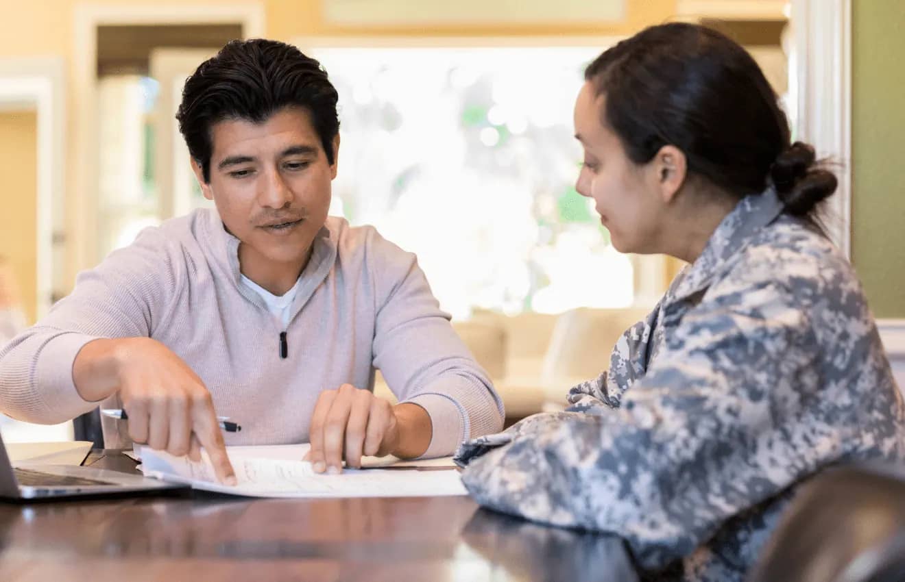 couple reviewing financial document - Budgeting Tips for Military Homebuyers