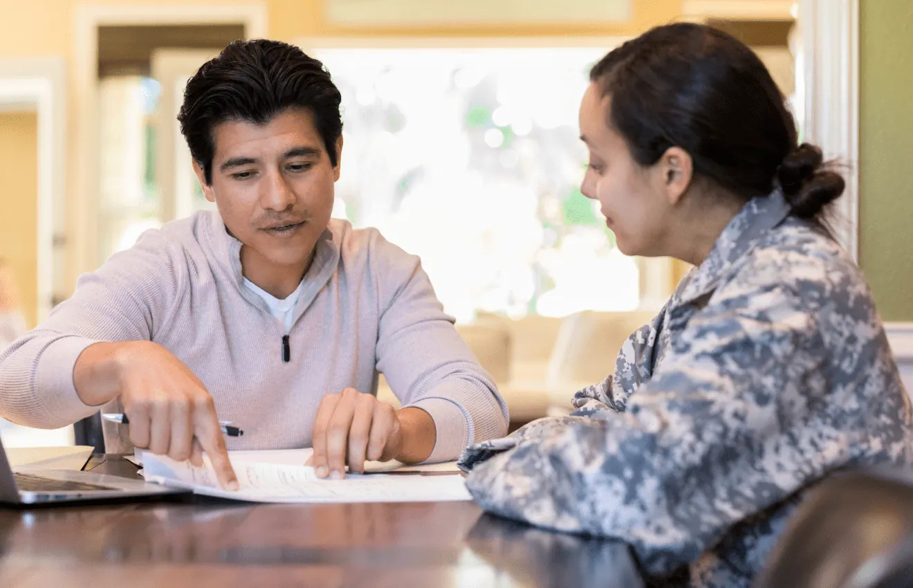 couple reviewing financial document - Budgeting Tips for Military Homebuyers