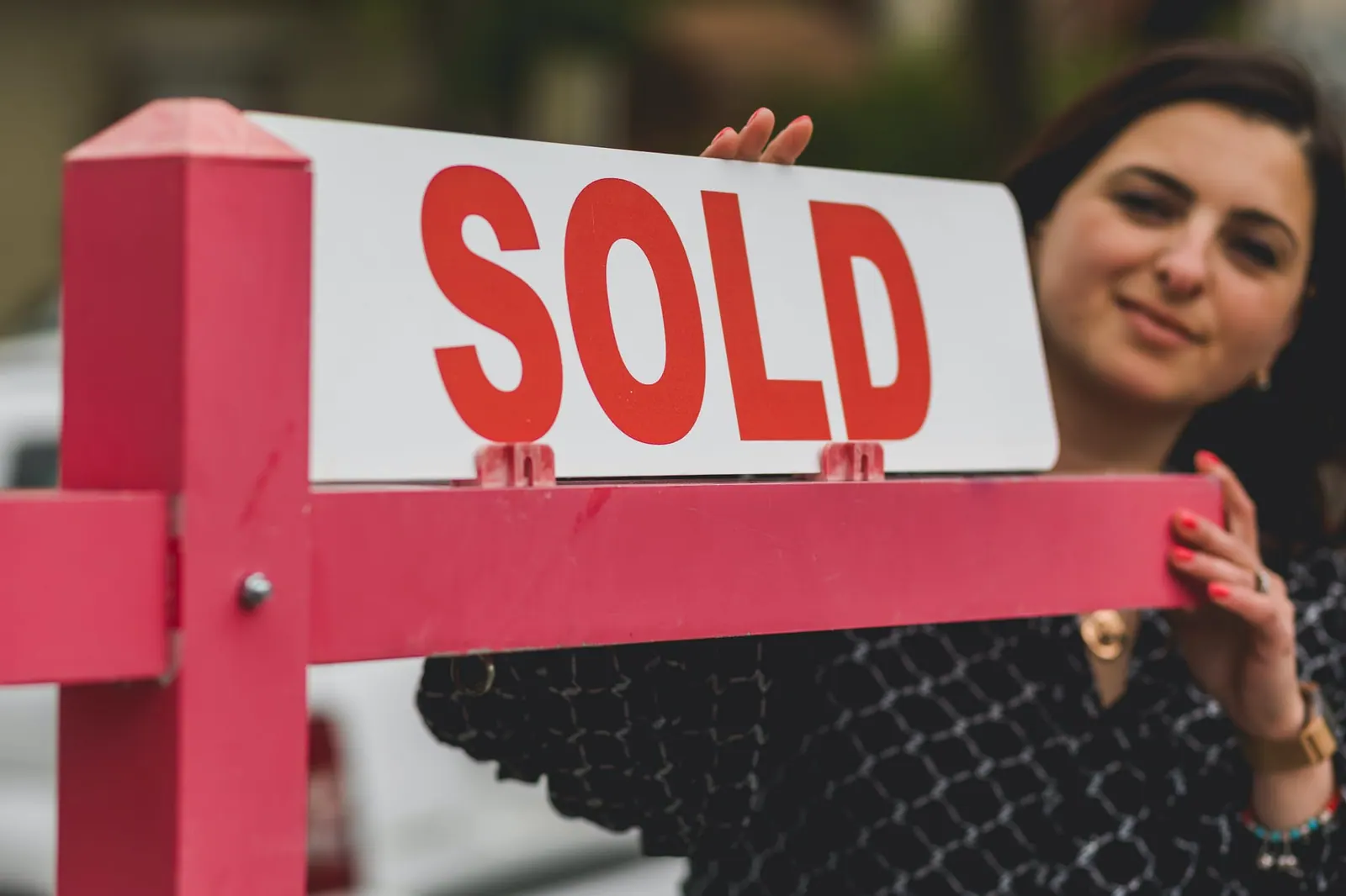 real estate agent holding a signage