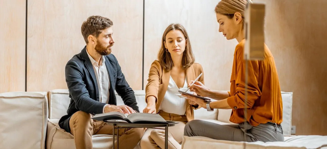 couple talking to an agent - Budgeting Tips for Military Homebuyers